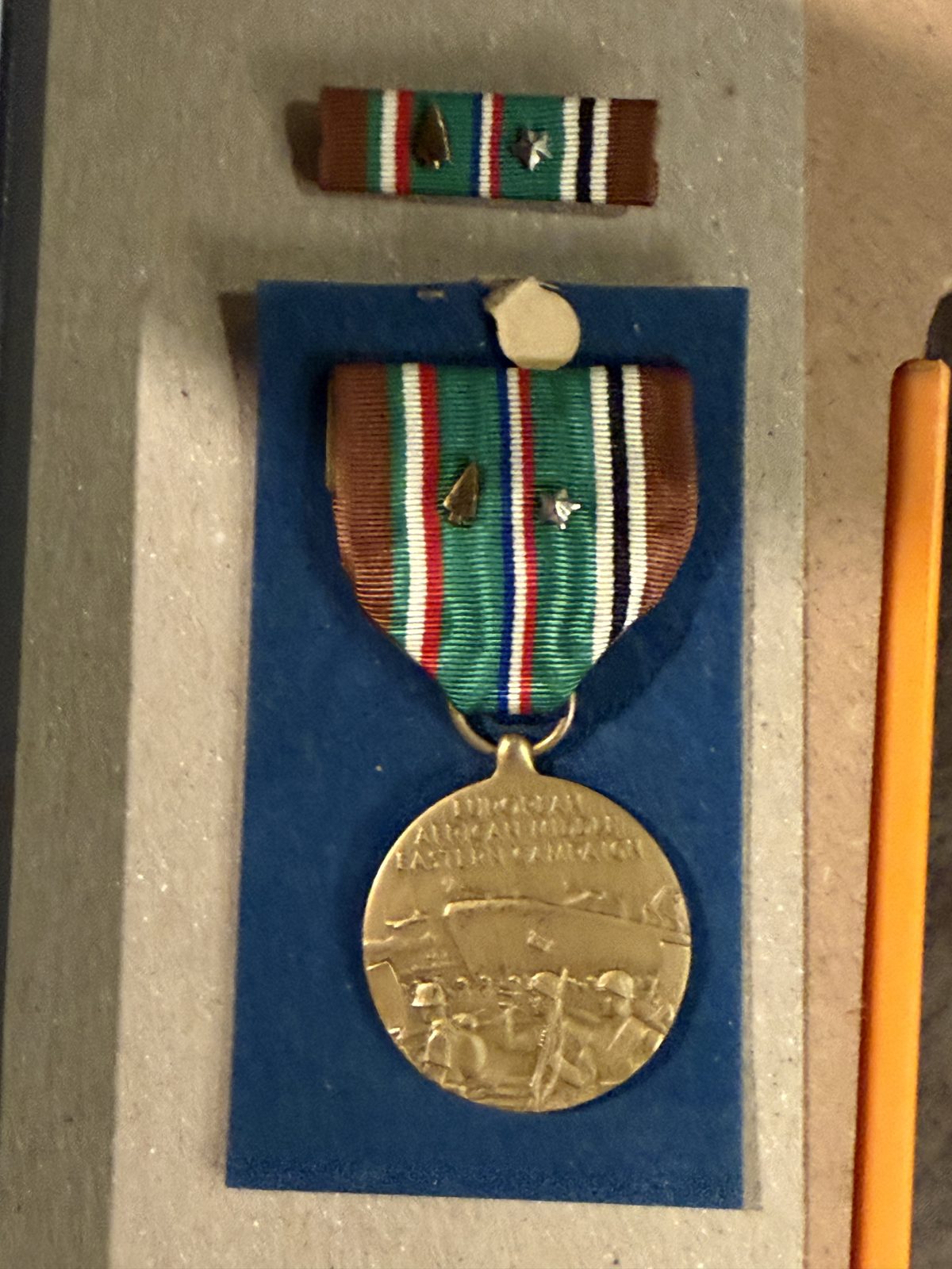 European-African-Middle Eastern Campaign Medal — the ribbon bar carries battle stars and a bronze arrowhead for an assault landing.