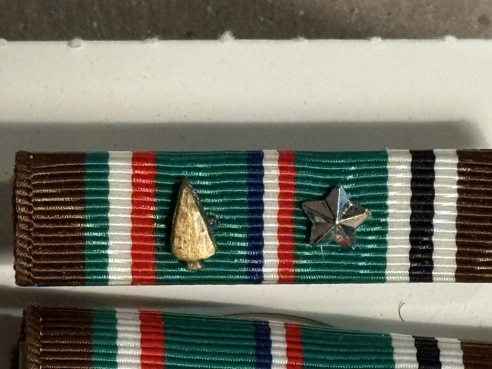 A closer look at the European ribbon: the silver service star stands for five campaign credits, and the bronze arrowhead marks the assault landing at Utah Beach.