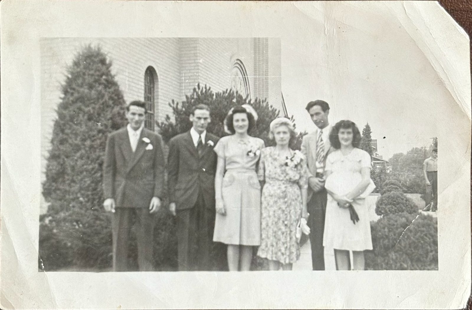 A wedding group outside the church — George among family and friends.