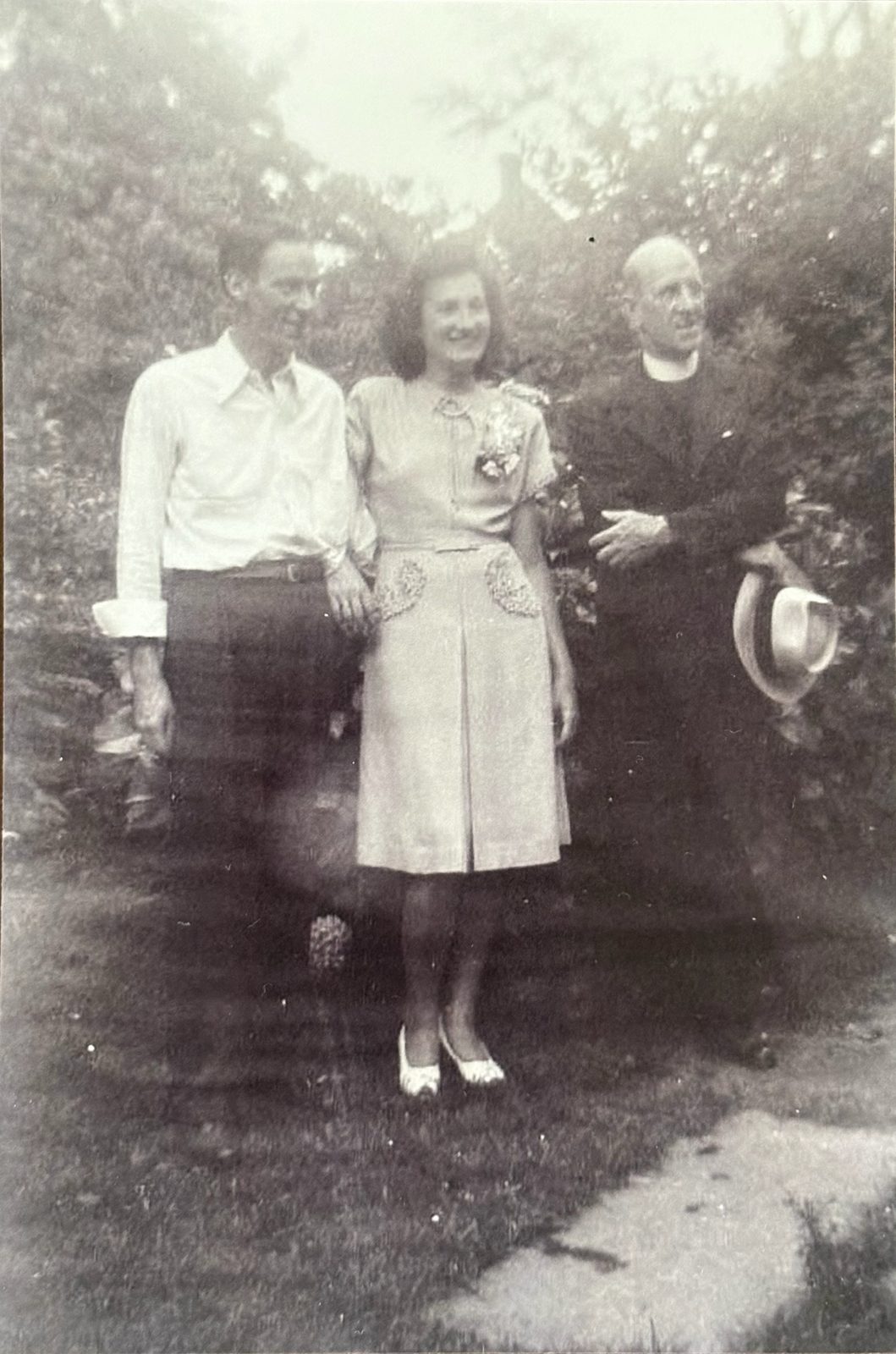 George, Mary, and a priest (likely Father Doyle, who appears throughout the letters) in the churchyard.